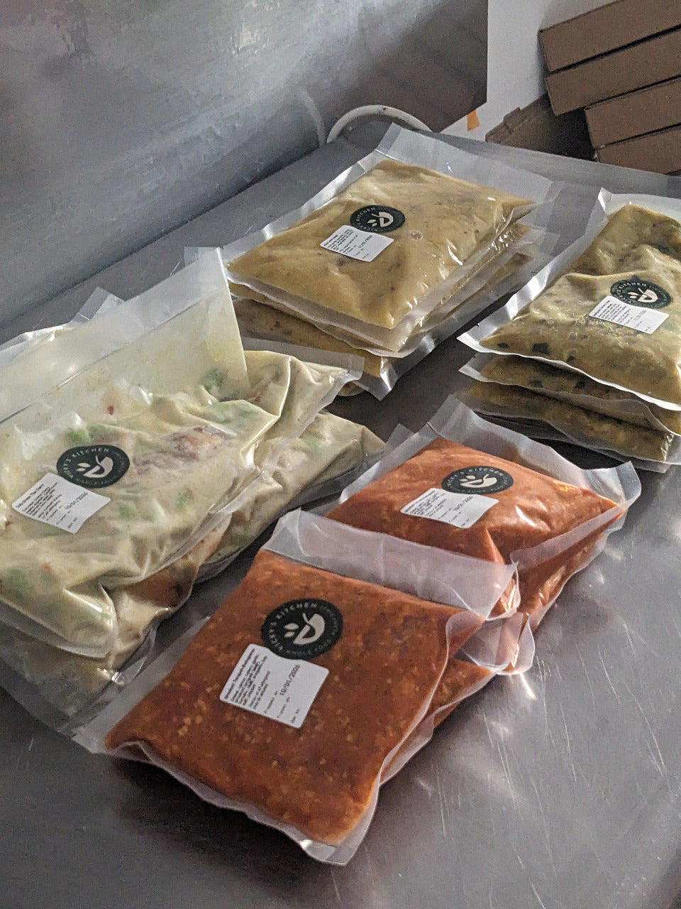 Packages of food with labels on a metallic surface