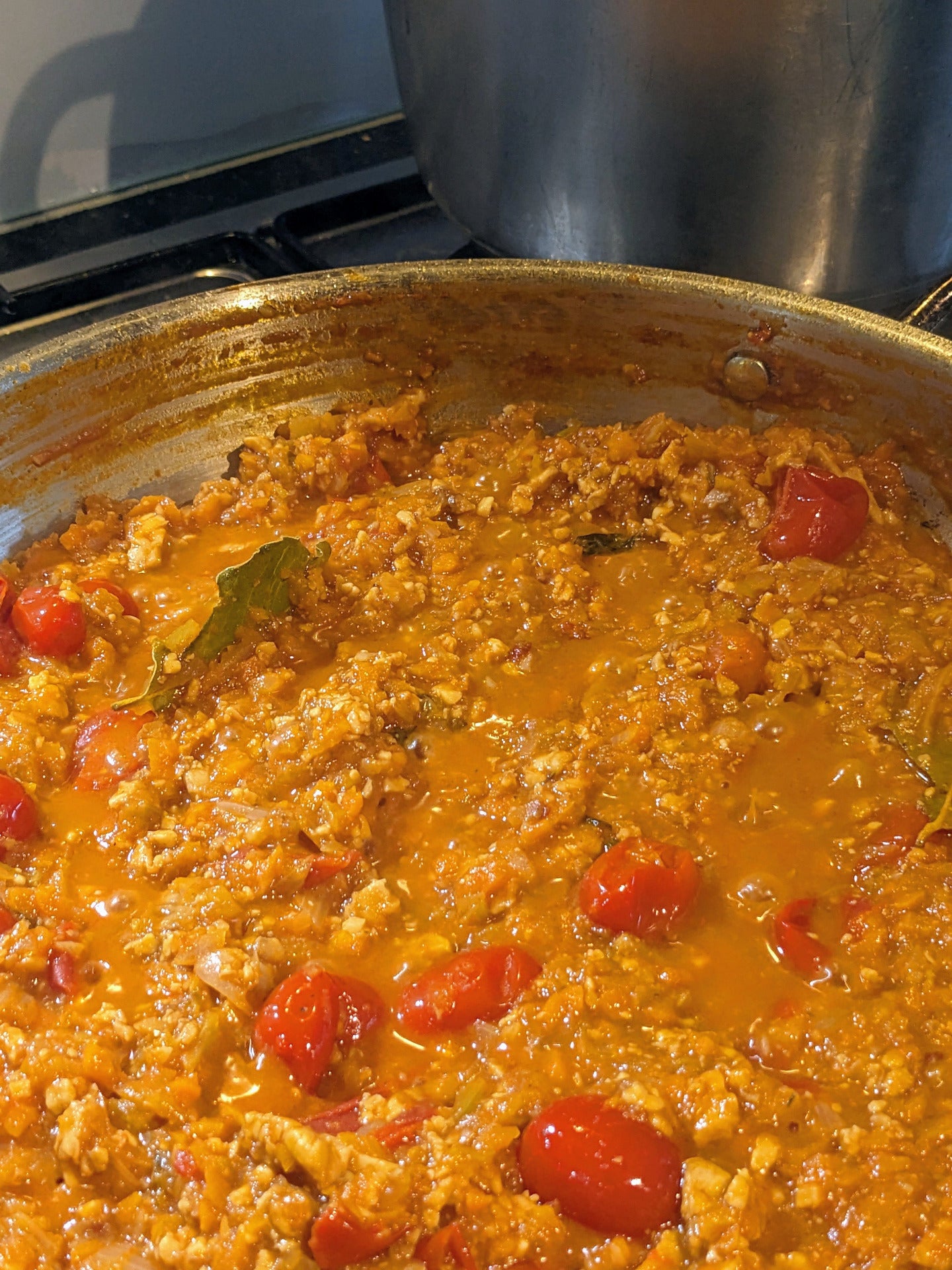 Close-up of my tempeh bolognese simmering on the stove, showing the rich vegan sauce.