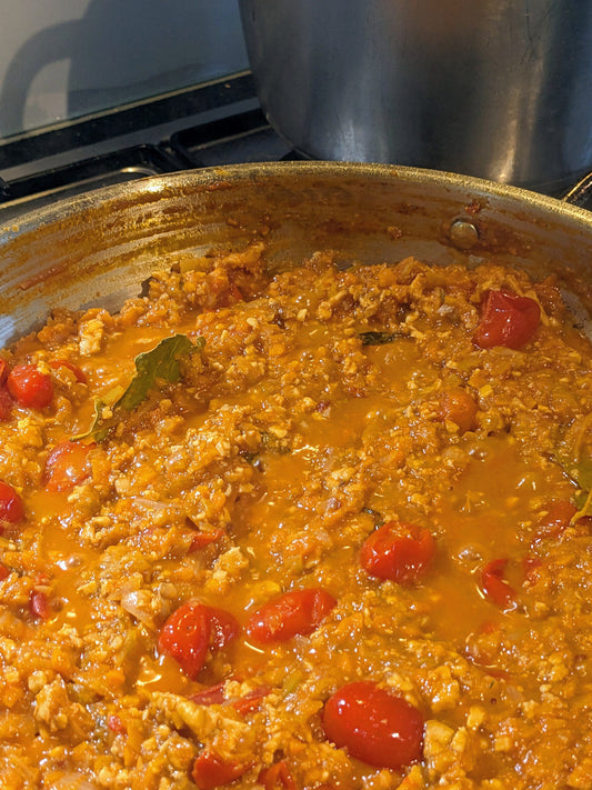 Close-up of my tempeh bolognese simmering on the stove, showing the rich vegan sauce.